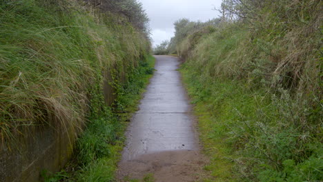 Mid-shot-looking-up-a-old-military-concrete-road-going-to-the-beach-at-Theddlethorpe,-Dunes,-National-Nature-Reserve-at-Saltfleetby