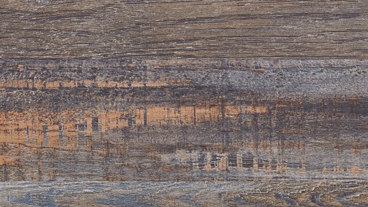 Close-up slow pan reveals unique wear marks across wooden tabletop