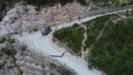 Small-electric-delivery-car-drives-up-the-mountain-to-supply-a-shelter