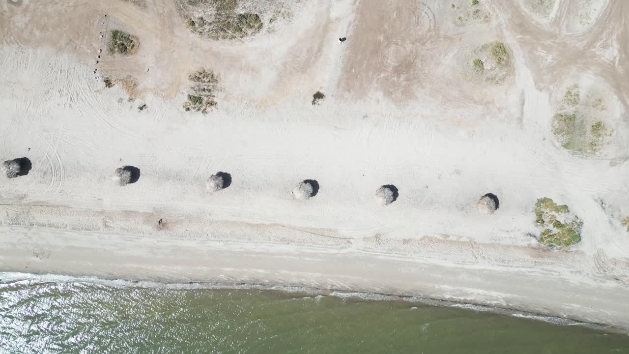 Lonely beach huts in a row on a quiet coast in La Paz, Baja California Sur