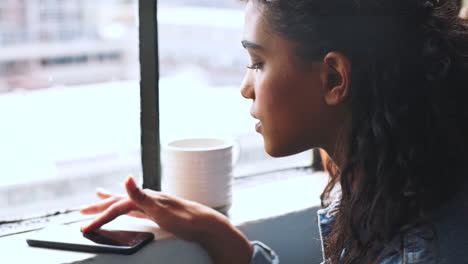 young woman looking out a window