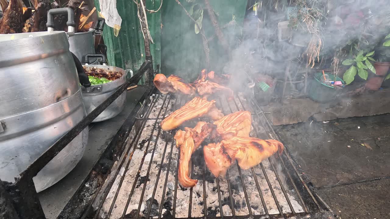 Grilled chicken cooking over open flames