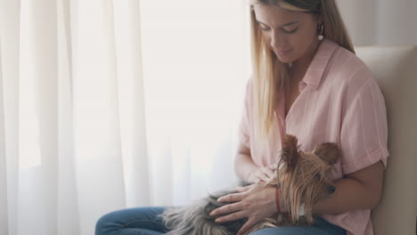 Young-Woman-Petting-Her-Little-Dog-At-Home-2