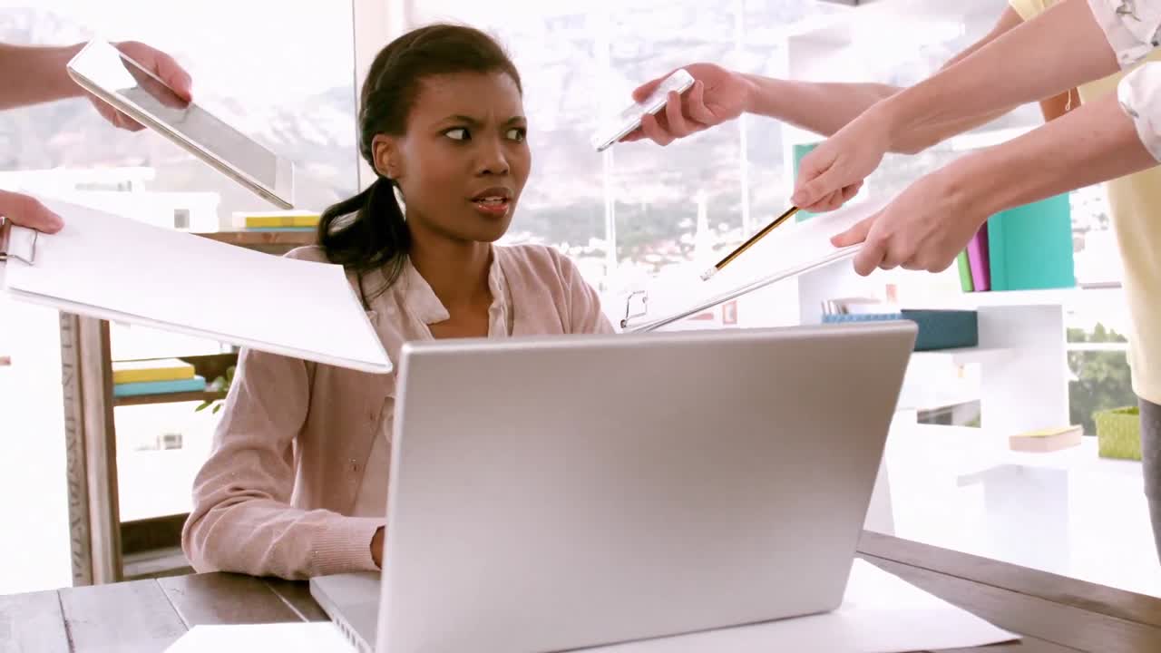 Businesswoman feeling overwhelmed at desk