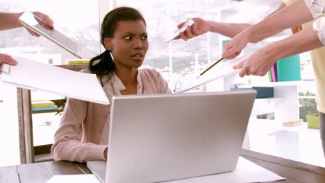 businesswoman feeling overwhelmed at desk