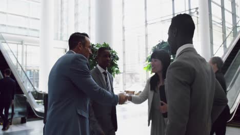 business people interacting with each other in the lobby at office 4k