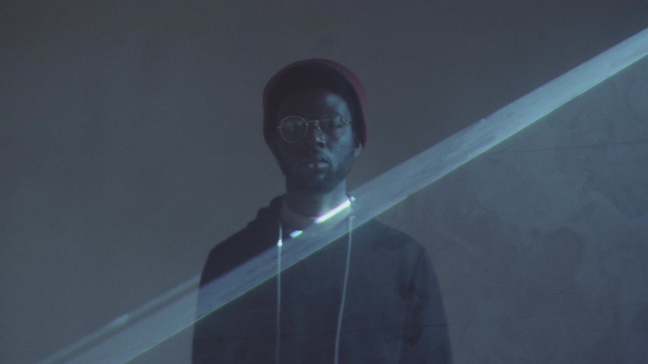 Afro-American Man Posing in Dark Studio with Laser Light