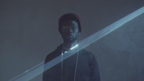 afro-american man posing in dark studio with laser light