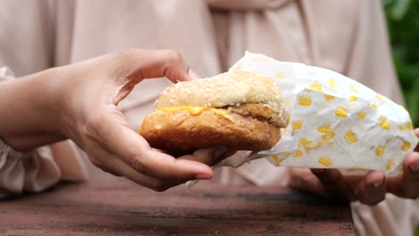 women hand holding beef burger top view ,