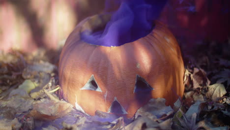 rotten halloween jack-o'-lantern with a thick cloud of purple smoke billowing out of it