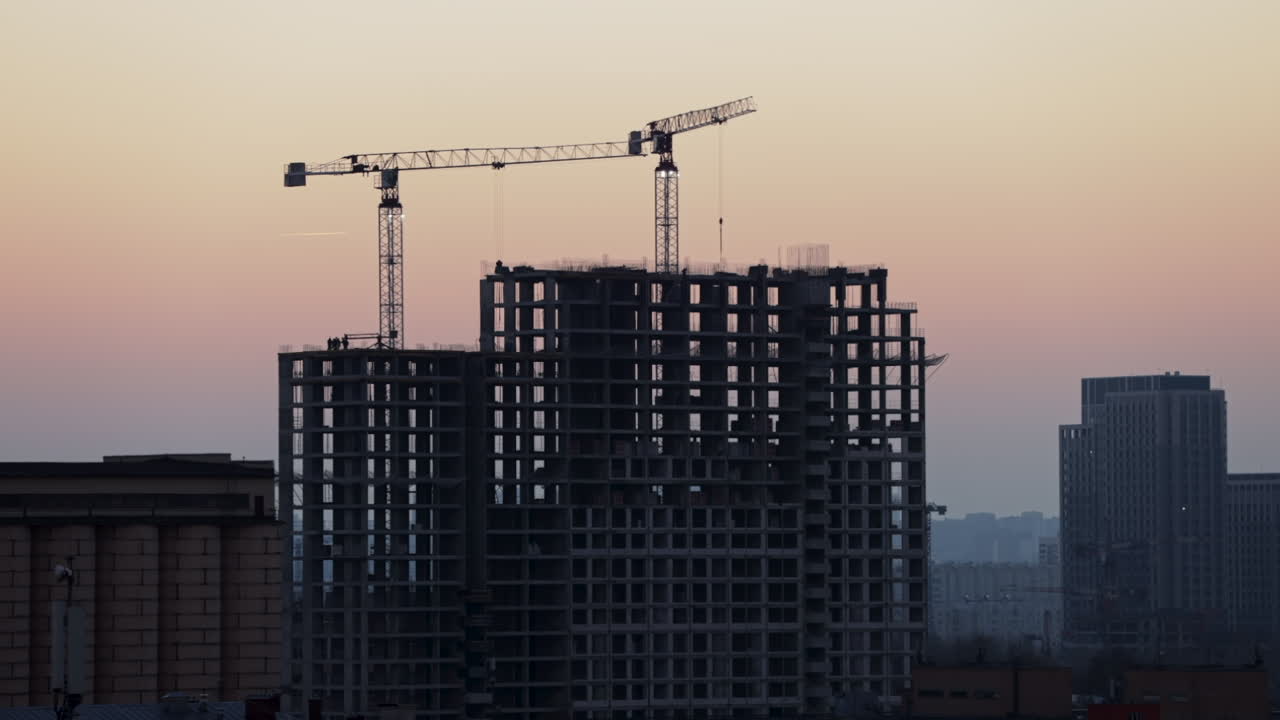 Construction of a High-Rise Building at Sunset