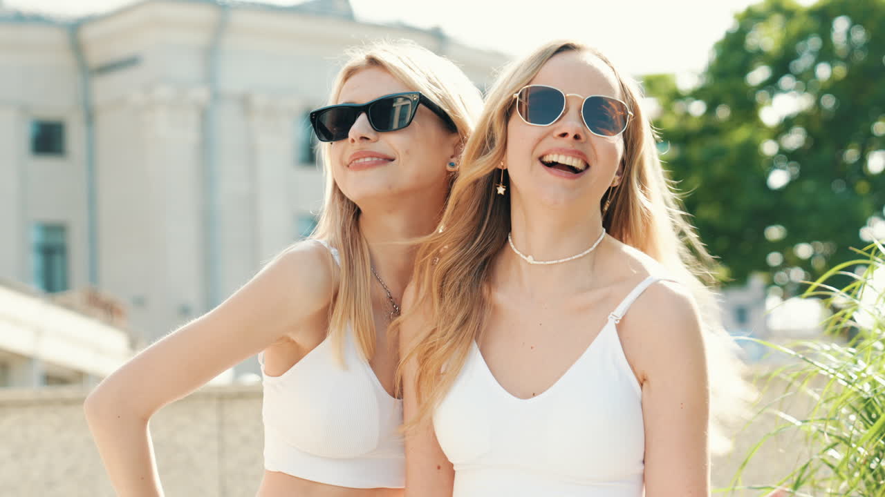 선글라스를 입은 두 명의 행복한 금발 여성