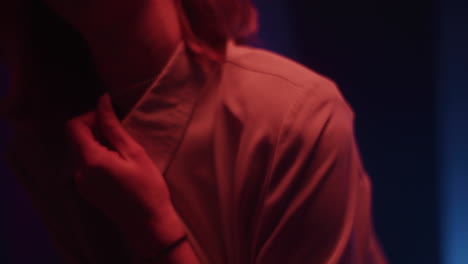 woman in a red-lit shirt