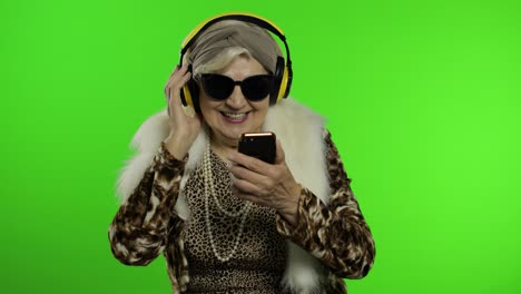 elderly grandmother. caucasian woman. dance, celebrate, listen music. chroma key