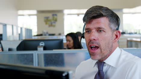 White-middle-aged-man-working-at-a-call-centre,-close-up