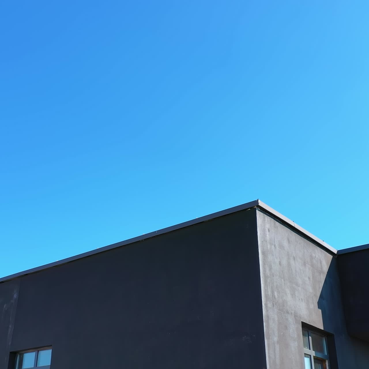 Block of flats on sky background. Modern high-rise apartment building with windows and large balconies