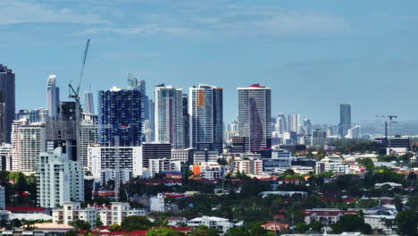 4K-Telephoto-Flyover-Gold-Coast-Australia-Skyline-With-High-Rise-Cityscape-On-Sunny-Day,-Drone