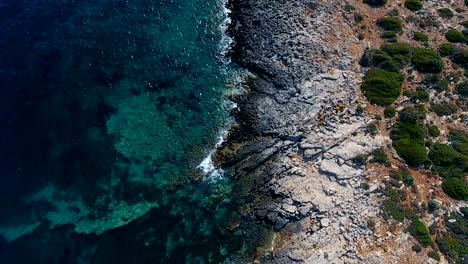 aerial footage of beautiful steep rocky coast line, turquoise ocean water, big cliffs coast line. 4k