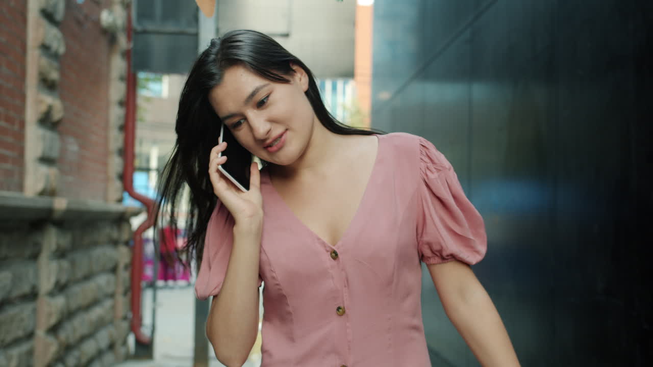 Woman Walking and Talking on Phone in the City