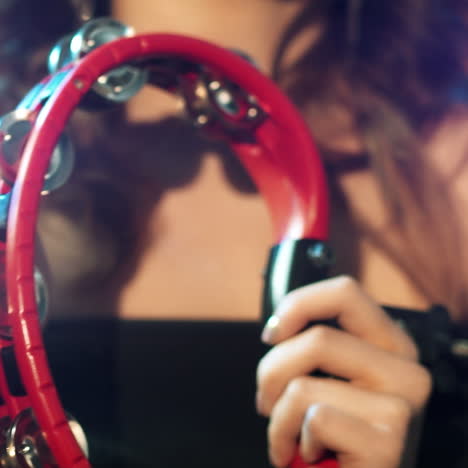 young woman is playing on the tambourine in studio square video