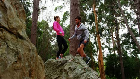 Couple jumping on a rock