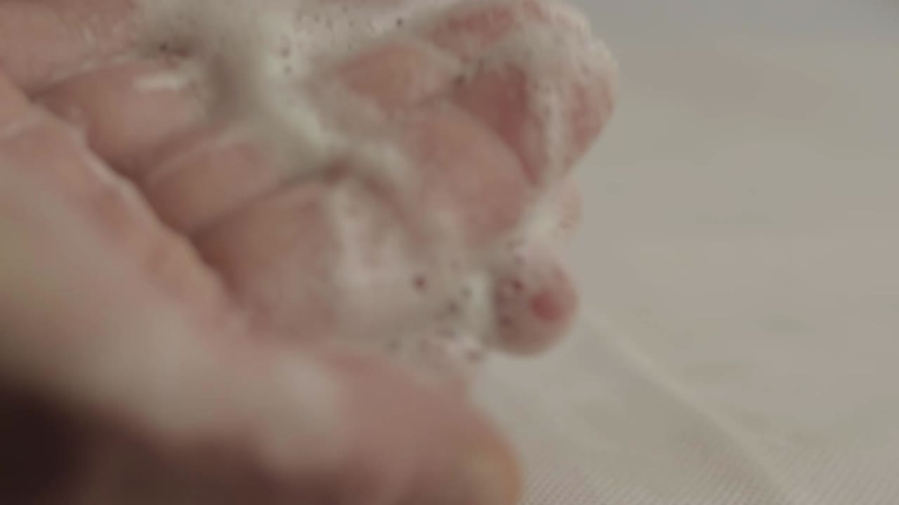 Washing hands with soapy water macro shot