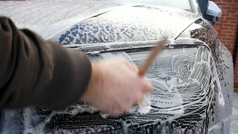 cleaning car headlight with a detailing brush