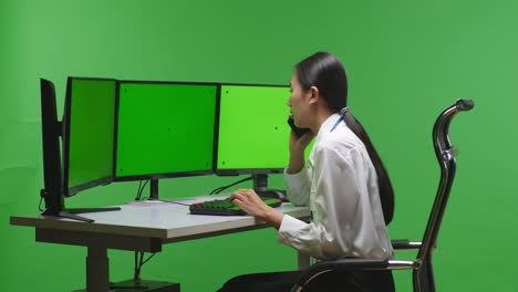 woman on phone call at a computer