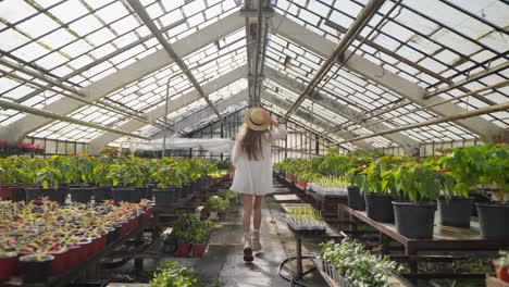 woman walking through a greenhouse