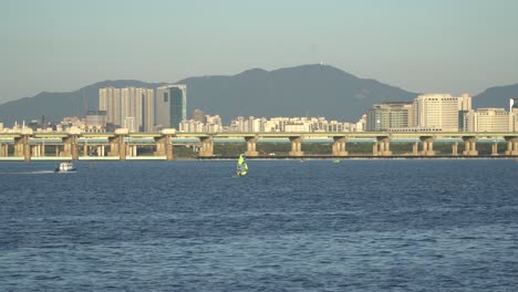 jamsil bridge, windsurfer on han river seoul, south korea daytime wide shot