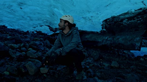 man in a cave in the perito moreno glacier, the most iconic glacier in the world