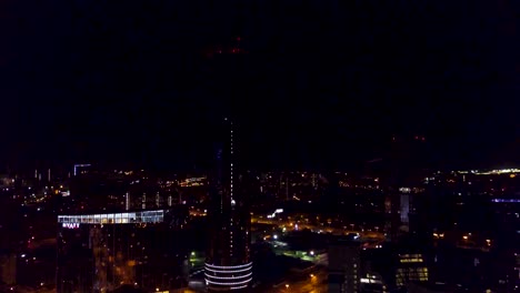 night view of a modern city with a tall skyscraper