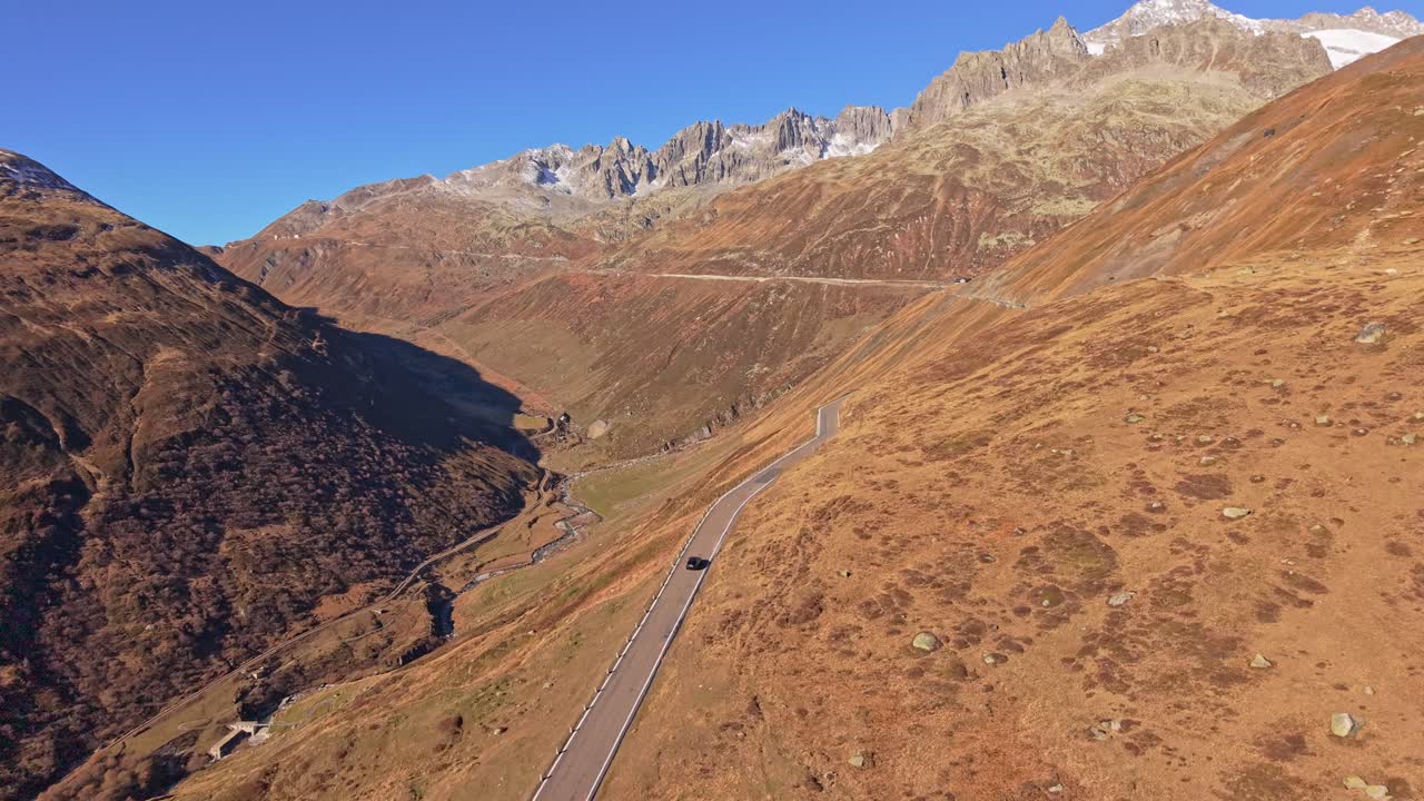 Aerial panorama of Furka Pass lit by sun in the heart of Switzerland