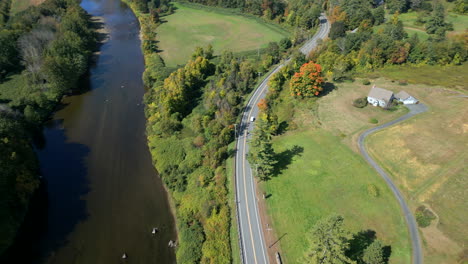 high angle aerial overview above biker group riding along mohawk trail by deerfield river in western massachusetts new england usa