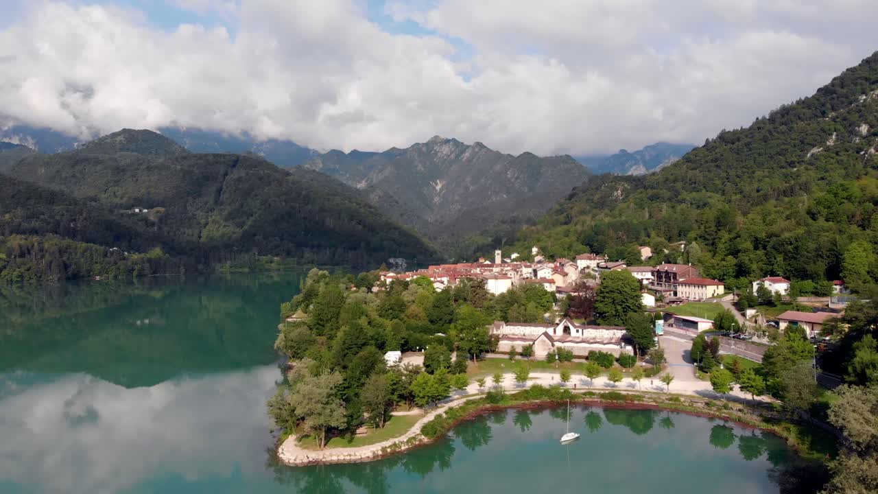 Slow flight towards Barcis Dolomites northern Italy with great view over teal lake and mountain panorama