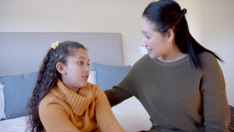 biracial mother and daughter share a moment at home