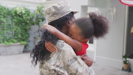 animation of happy african american soldier mother and daughter hugging and embracing