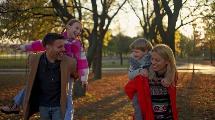 Family having fun in the park during autumn