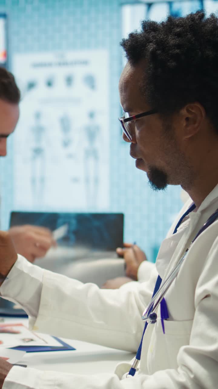 Vertical Video Medical experts analyze radiography scans in a meeting with the staff