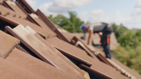 Blurred-worker-on-roof-installing-eco-friendly-solar-panel,-railing-mounts