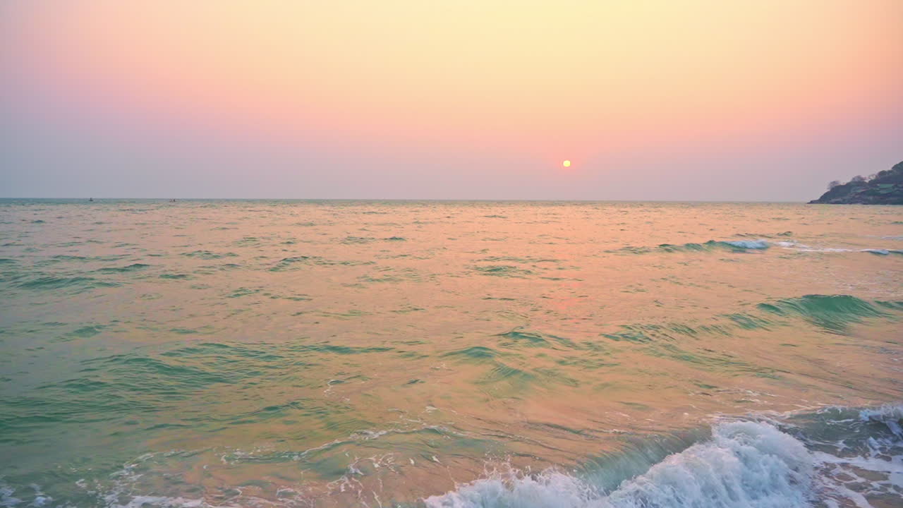 Sea tides glowing, mirroring sunset on turquoise waters panorama