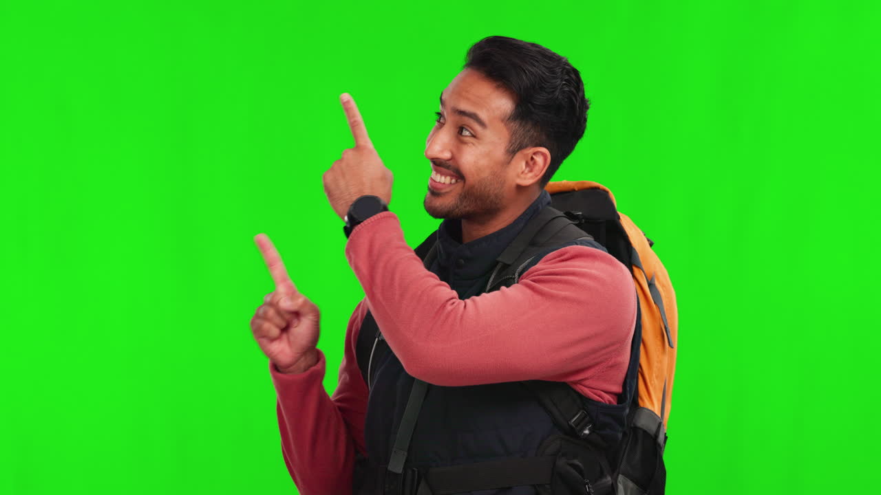 Homem asiático, mochila e apontando em fundo verde