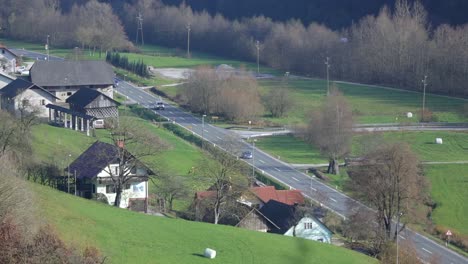 Long-shot-of-local-road-traffic-and-highway-in-background