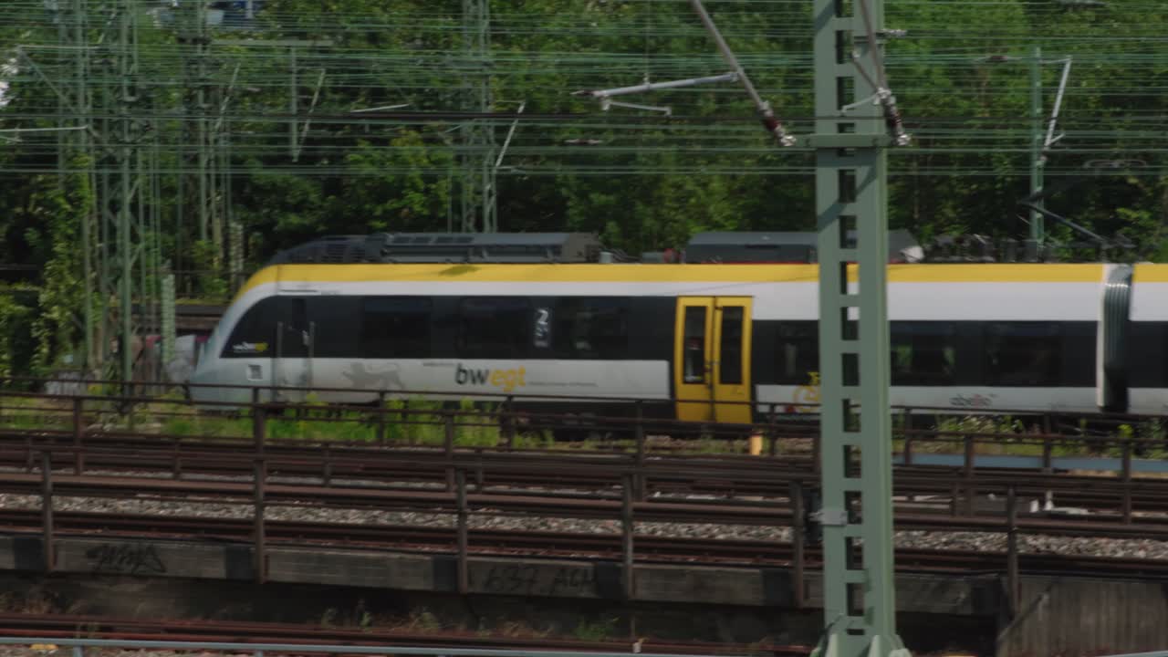 A modern passenger train speeds along railway tracks, showcasing regional public transport in Germany.