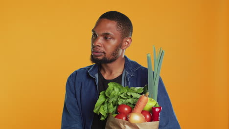 young adult talking about organic locally grown produce in line at grocery store