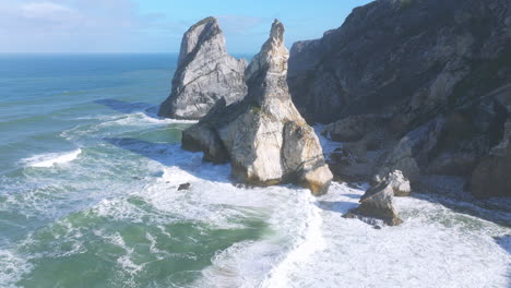 dramatic aerial view of rocky coastline and crashing waves