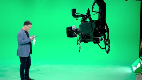 in a professional green screen studio, the camera jib shooting the television presenter. film and television industry