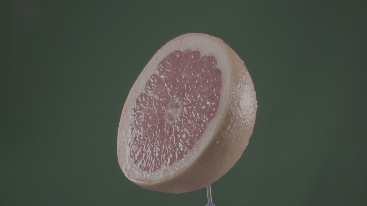 Grapefrukt som roterer i loop på grønn skjerm for chroma key