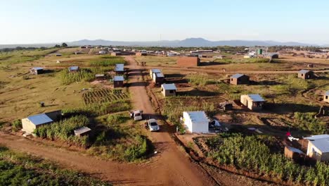 Family-Road-Trip-Visiting-African-Village-in-Malawi,-Aerial-Drone-View