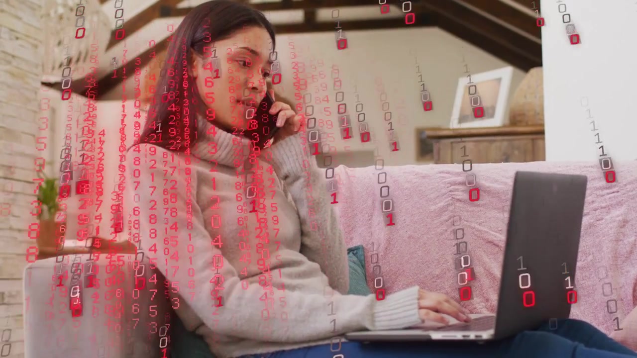 Woman typing on laptop and speaking phone working causing red IT overlay obscuring then fading